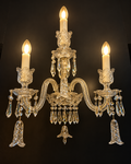 Warm Crystals 3-arm crystal wall sconce with candle lights and hanging crystal drops by Diamond Electrical Industries, Kolkata