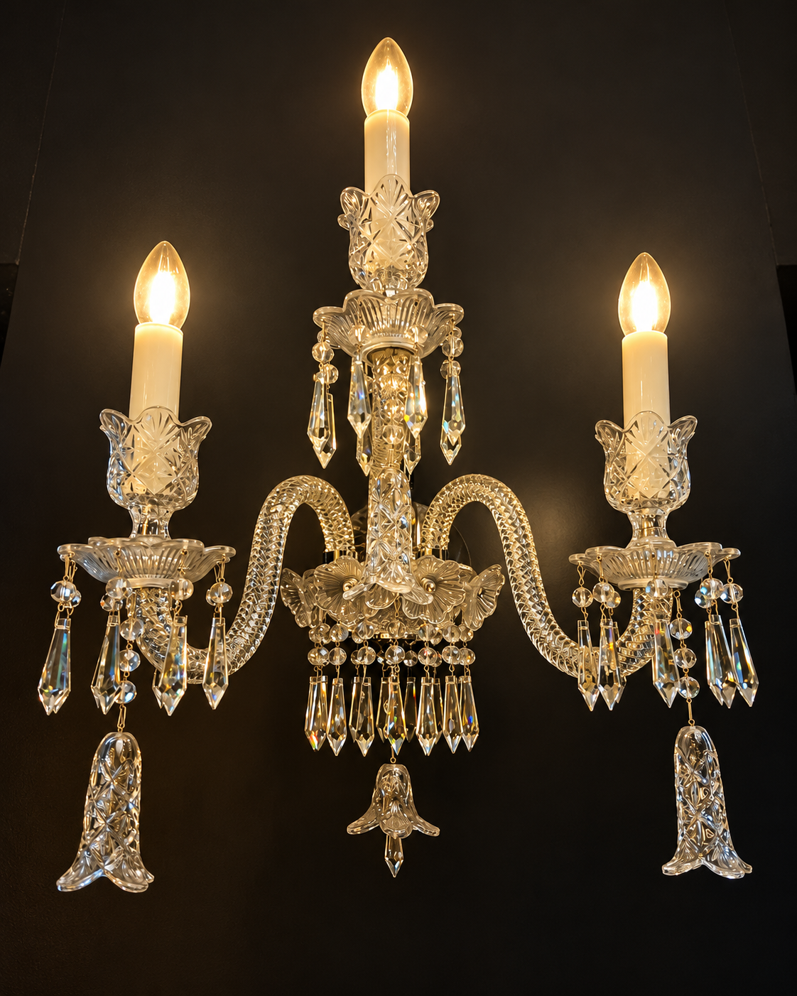 Warm Crystals 3-arm crystal wall sconce with candle lights and hanging crystal drops by Diamond Electrical Industries, Kolkata